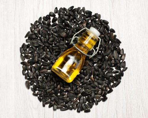 top-view-fresh-sunflower-seeds-black-colored-seeds-white-desk-photo-oil-snack-many-seed_140725-118135